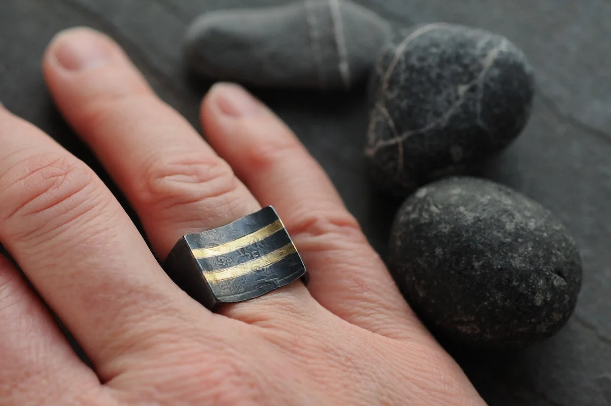 Black and gold stripe wide band ring with inverted curved top