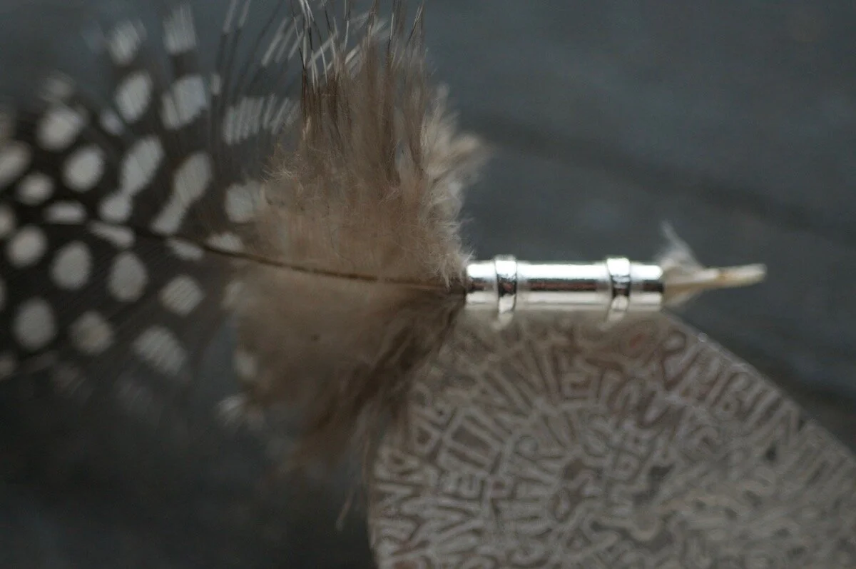 brooch with grouse feather