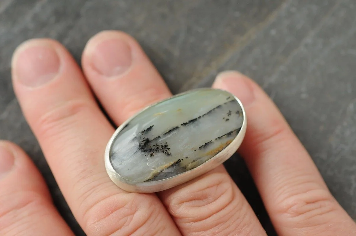 Contemporary statement ring in silver setting on models hand