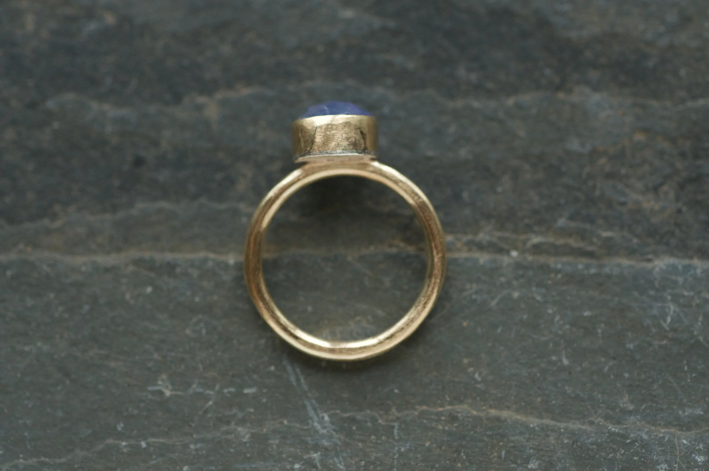 Gold ring shank set with blue tanzanite