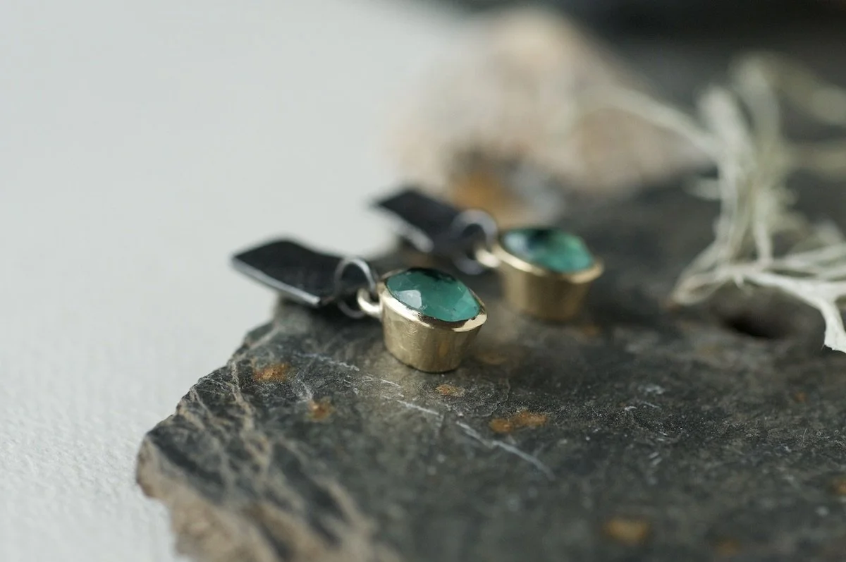 Contemporary Paraiba opal earrings showing the gold setting