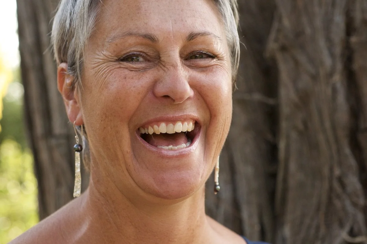 Model wearing similar mismatched Tahitian pearl earrings
