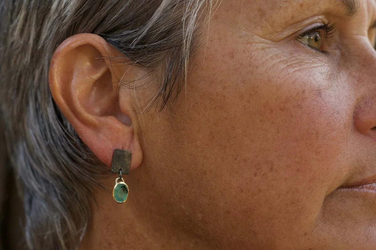 Model peruvian blue opal black and gold earrings.jpeg