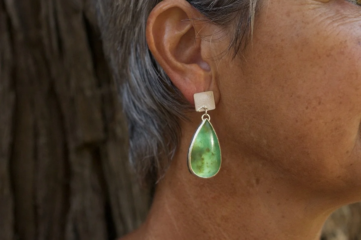 Model wearing statement Peruvian blue opal earrings
