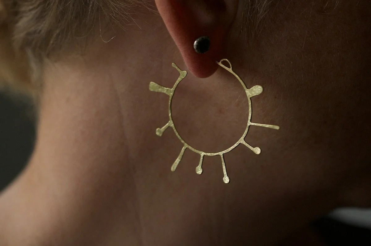 Large lichen hoops in gold vermeil on model.jpeg