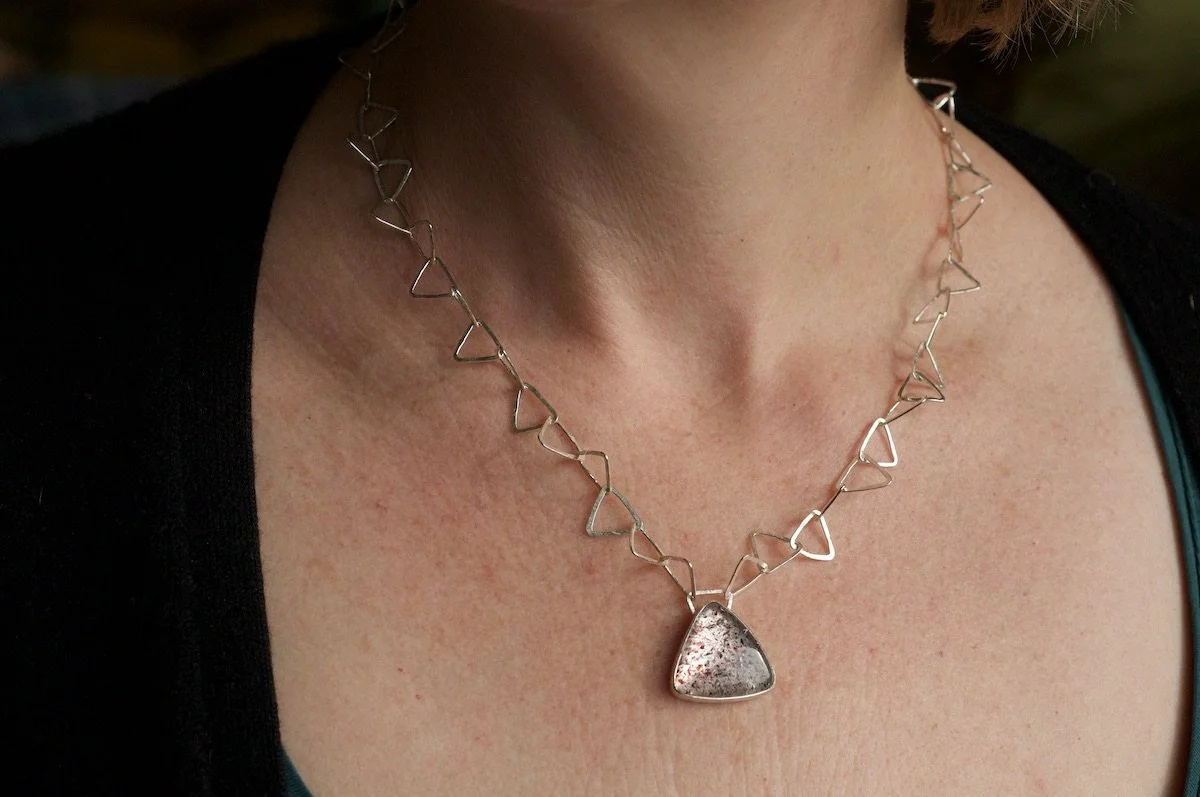 Fire quartz triangle necklace on model