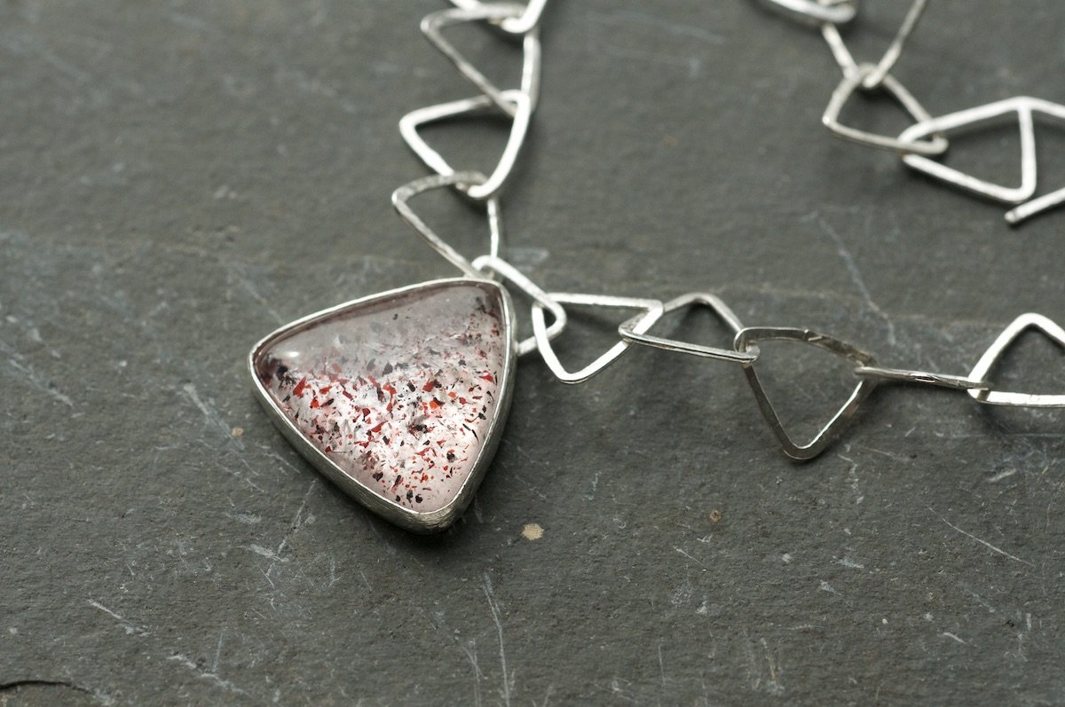 Fire quartz triangle necklace showing detail of the lepidocrocite stone