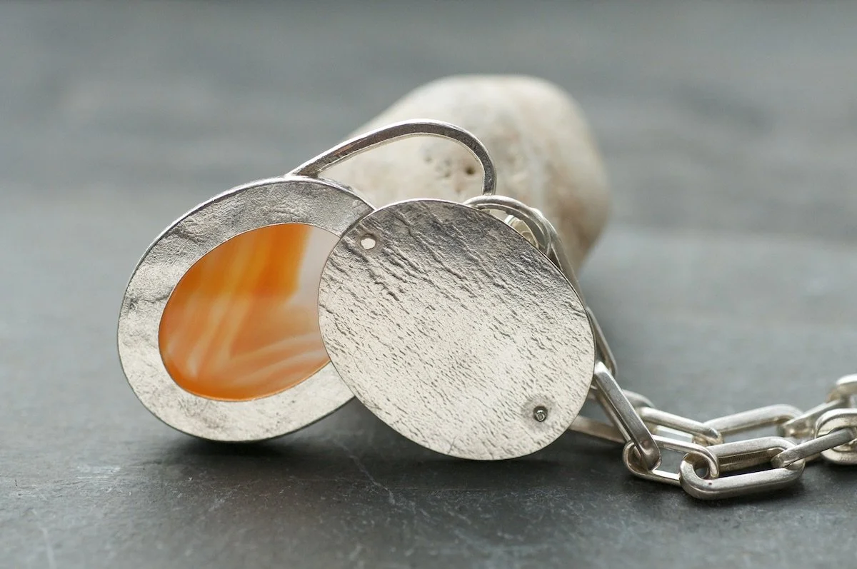 Banded carnelian and silver pendant