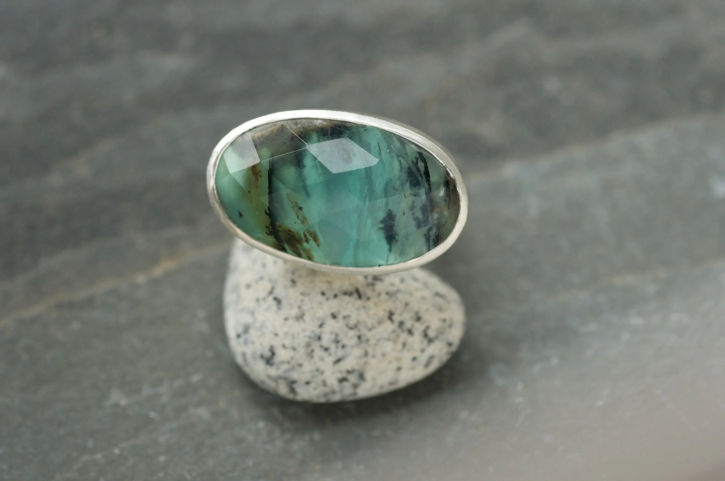 Peruvian blue opal rock pool ring on a pebble.jpeg