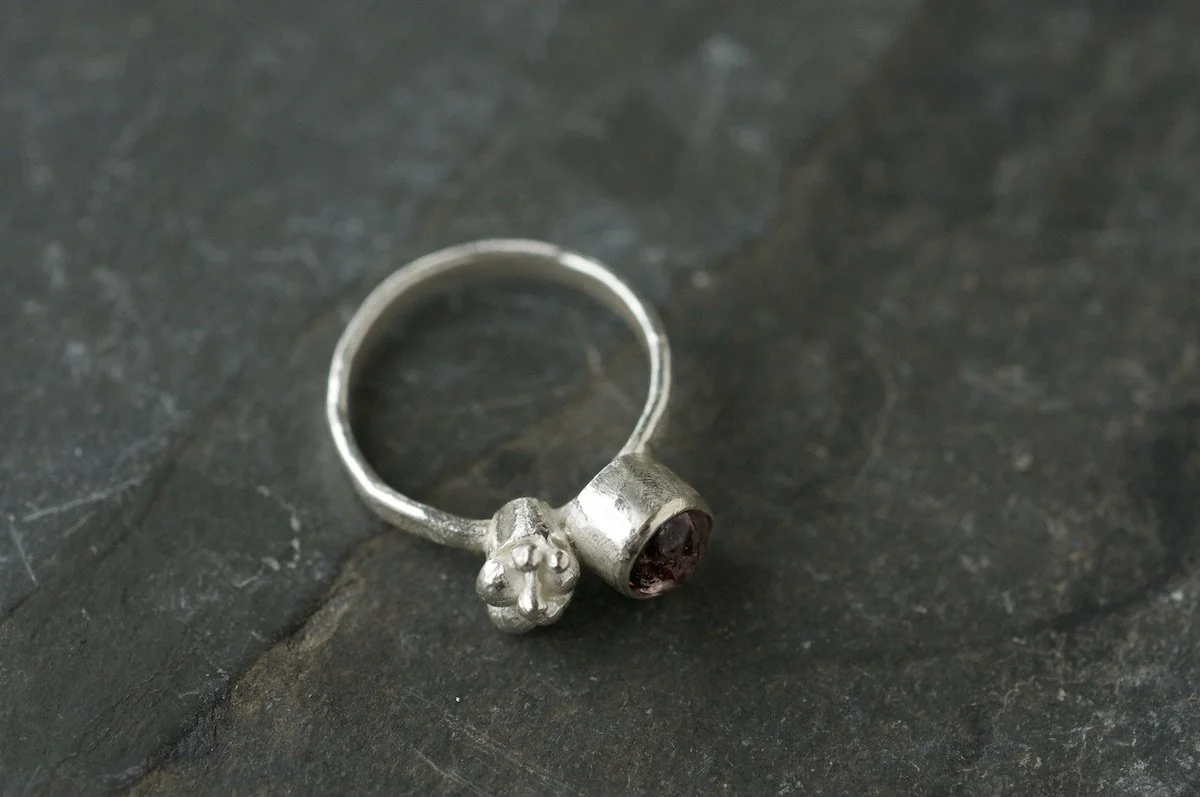 Fire quartz cabochon lichen cluster ring side view.jpeg