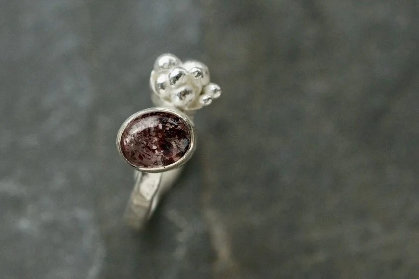 Fire quartz cabochon lichen cluster ring detail.jpeg