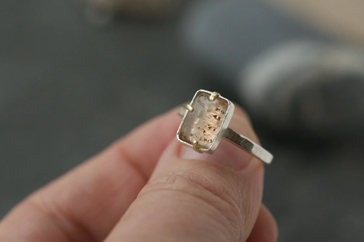 Rainbow lattice sunstone rectangle ring with gold claw setting.jpeg