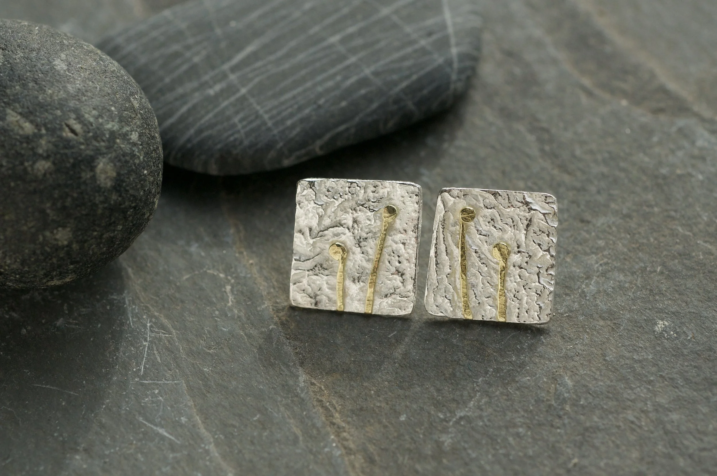 Reticulated silver with gold lichen details with pebble.jpeg