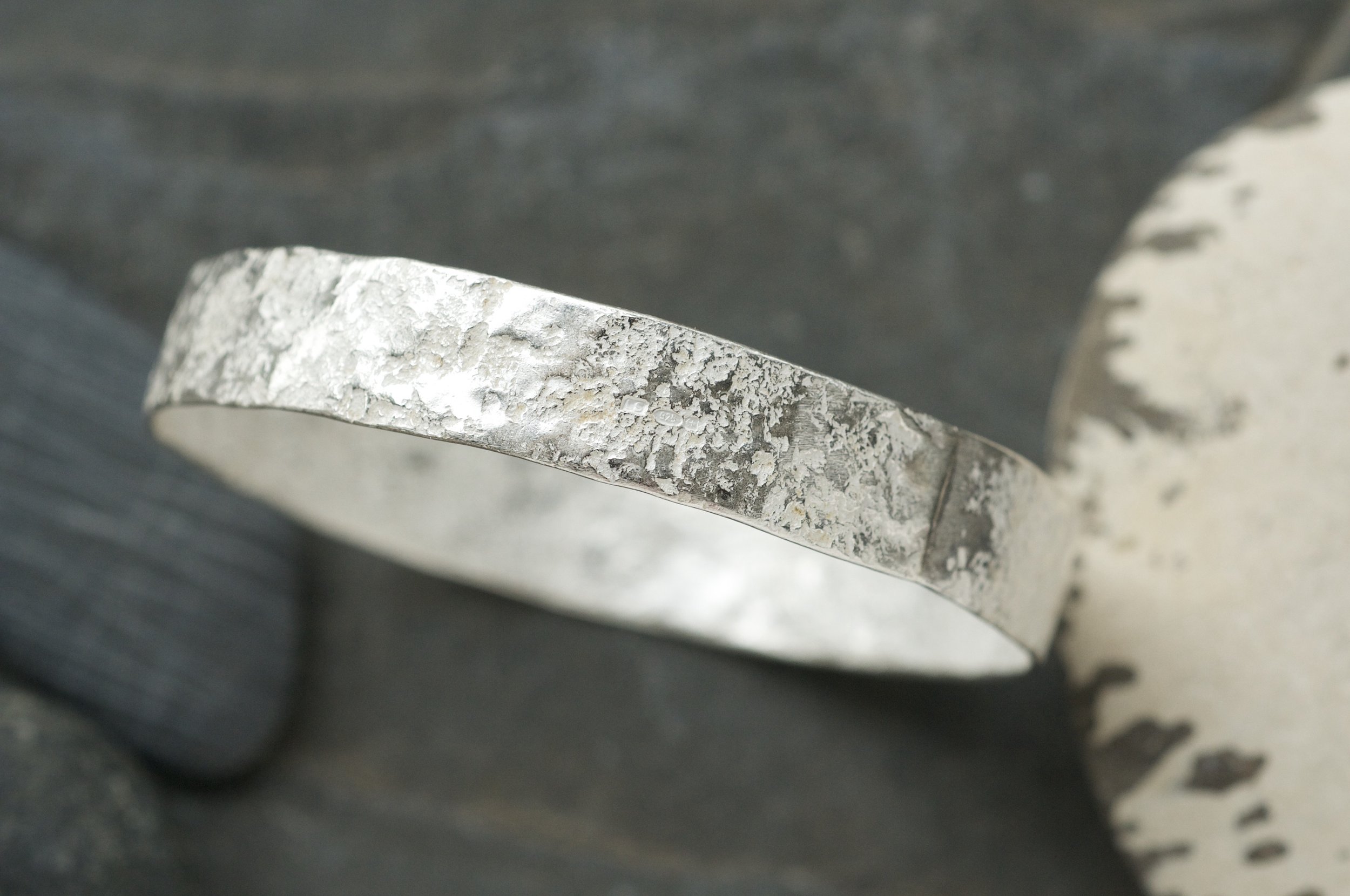 Granite hammered bangle showing solder line.jpeg
