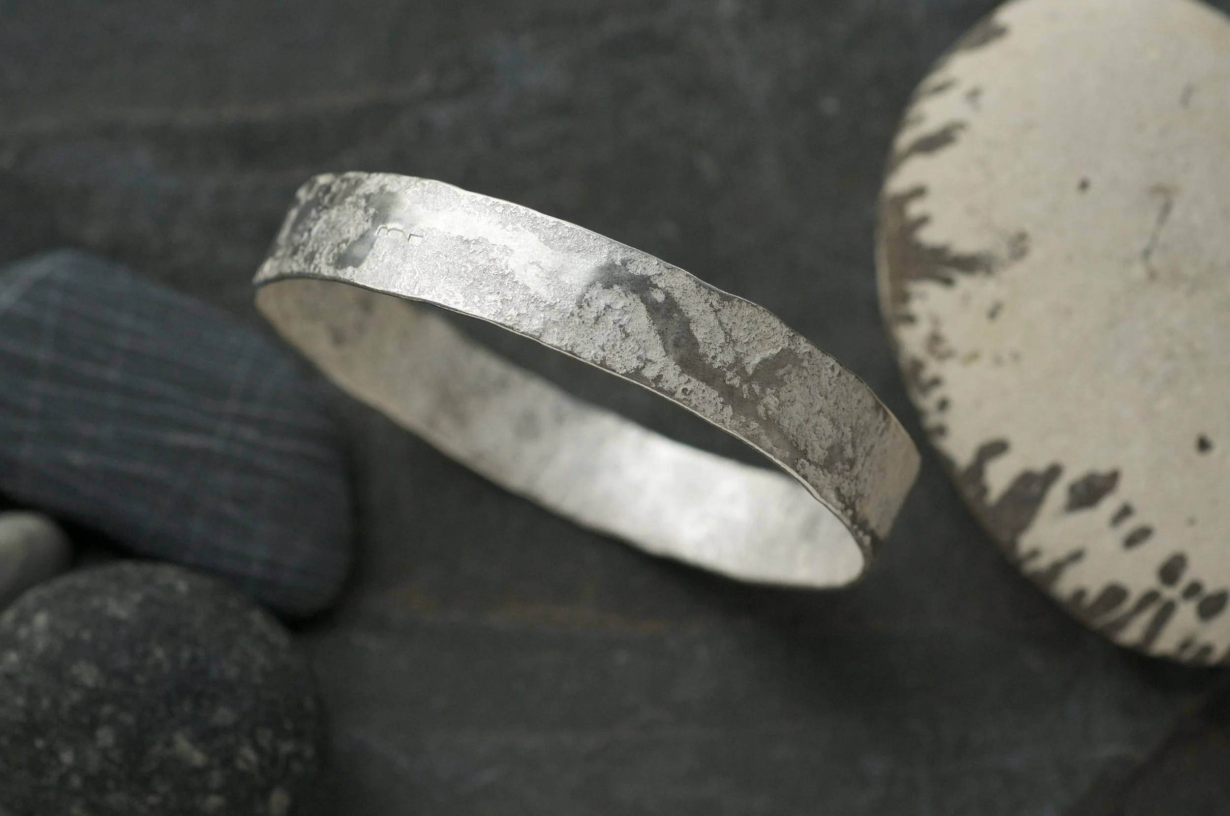 Granite hammered bangle with raised seam 2.jpeg