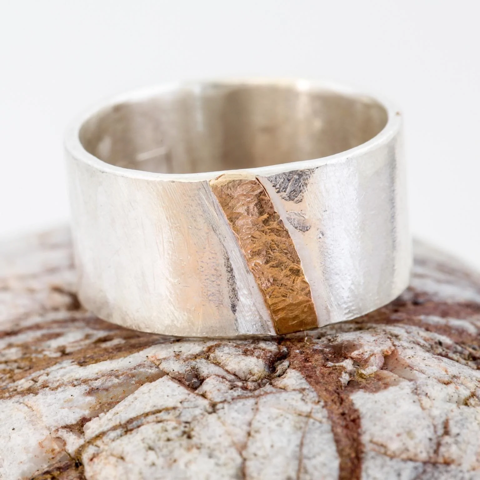 One of my best selling pieces, the Monolith ring with gold seam. Silver textured with my granddad&rsquo;s old workshop hammer, chunky silver jewellery that speaks of history and story. 

It was inspired by seams of quartz running through stones, a th