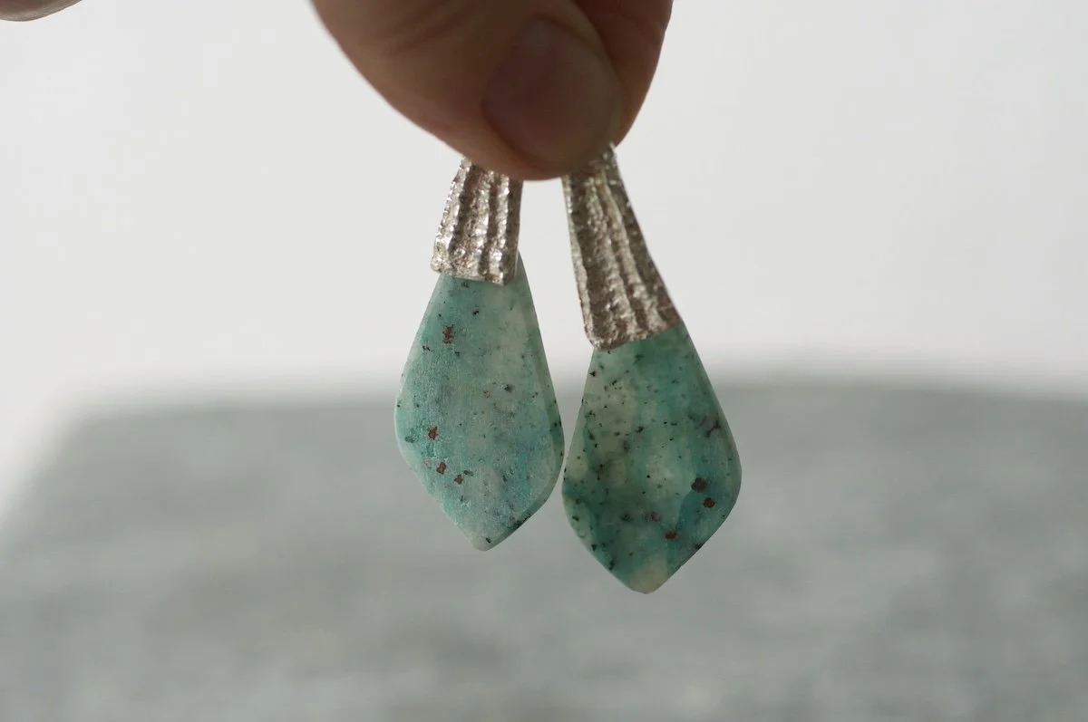 Stone slice earrings with limpet castings