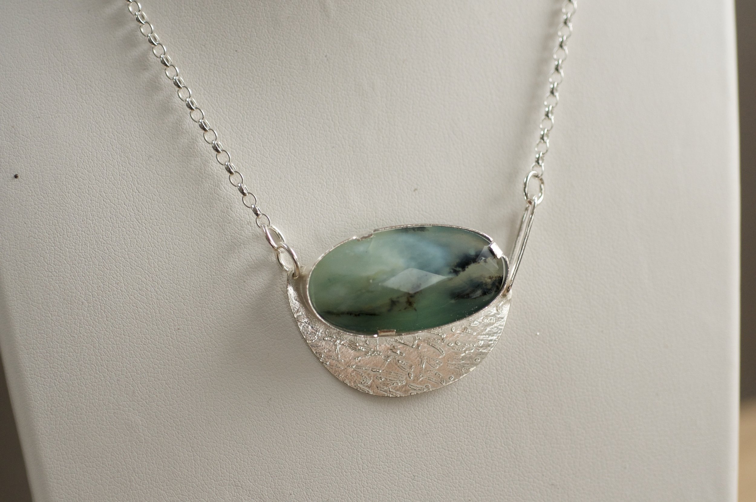 Faceted peruvian blue opal necklace on display.jpeg