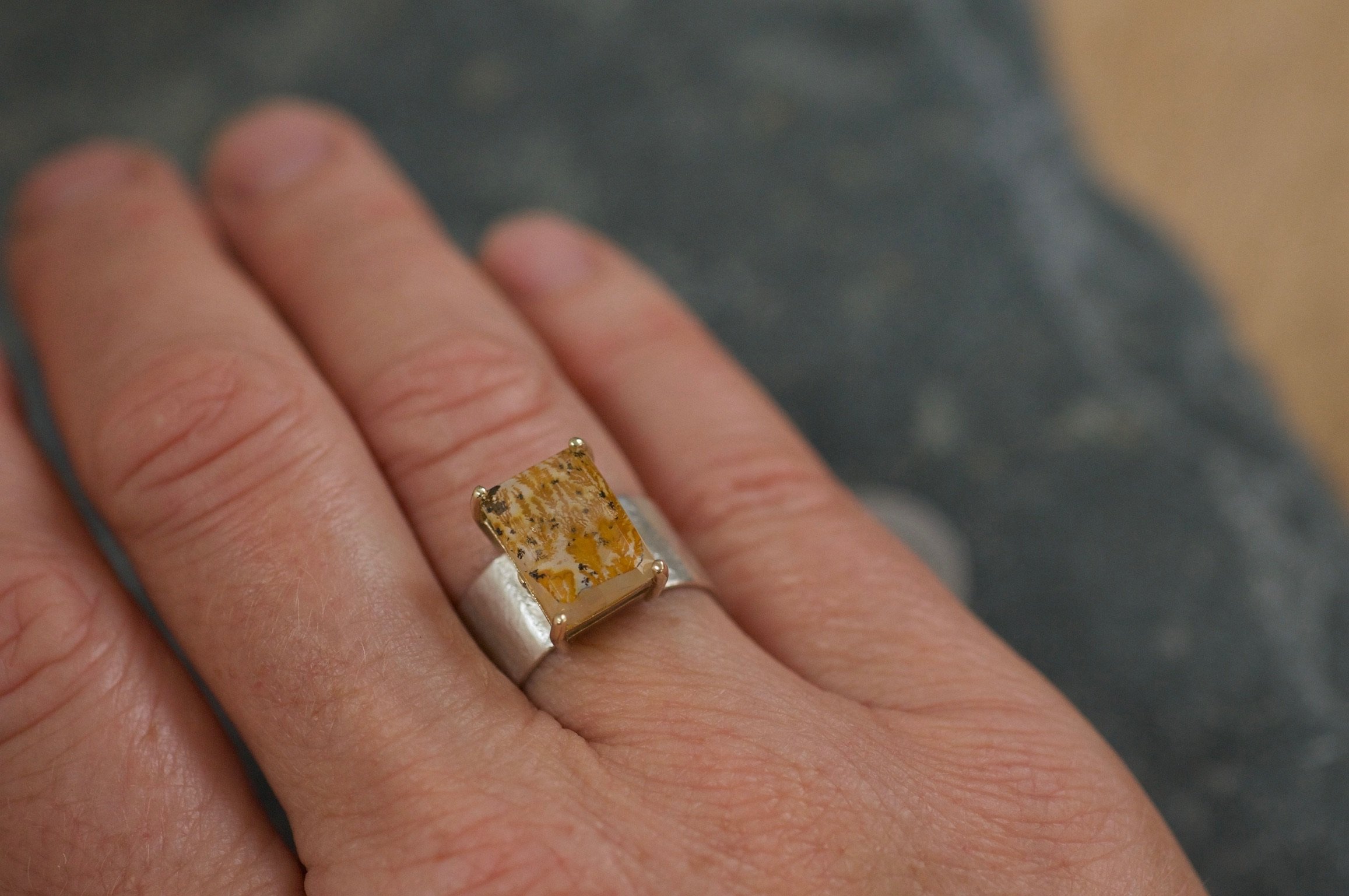 Dendritic agate ring on hand.jpeg