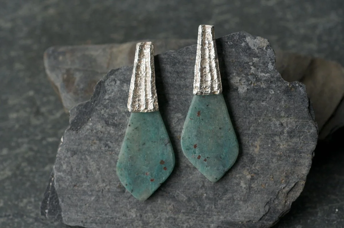 Stone slice earrings with limpet castings