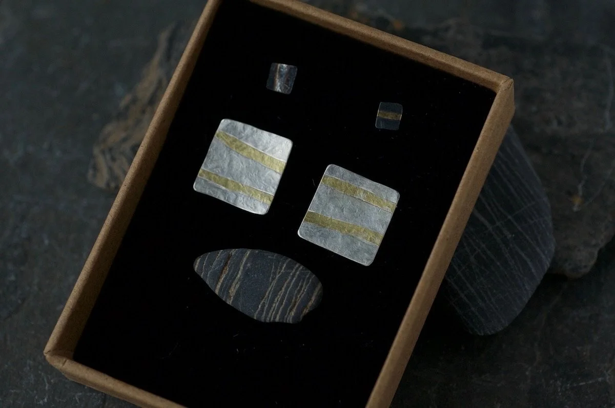 Gold and silver stripe square earrings in a jewellery box