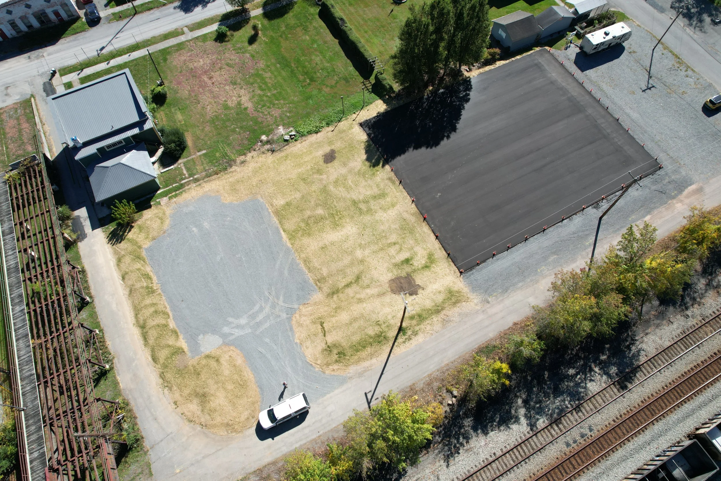  Site after construction of parking lot and paved future pickleball court area 