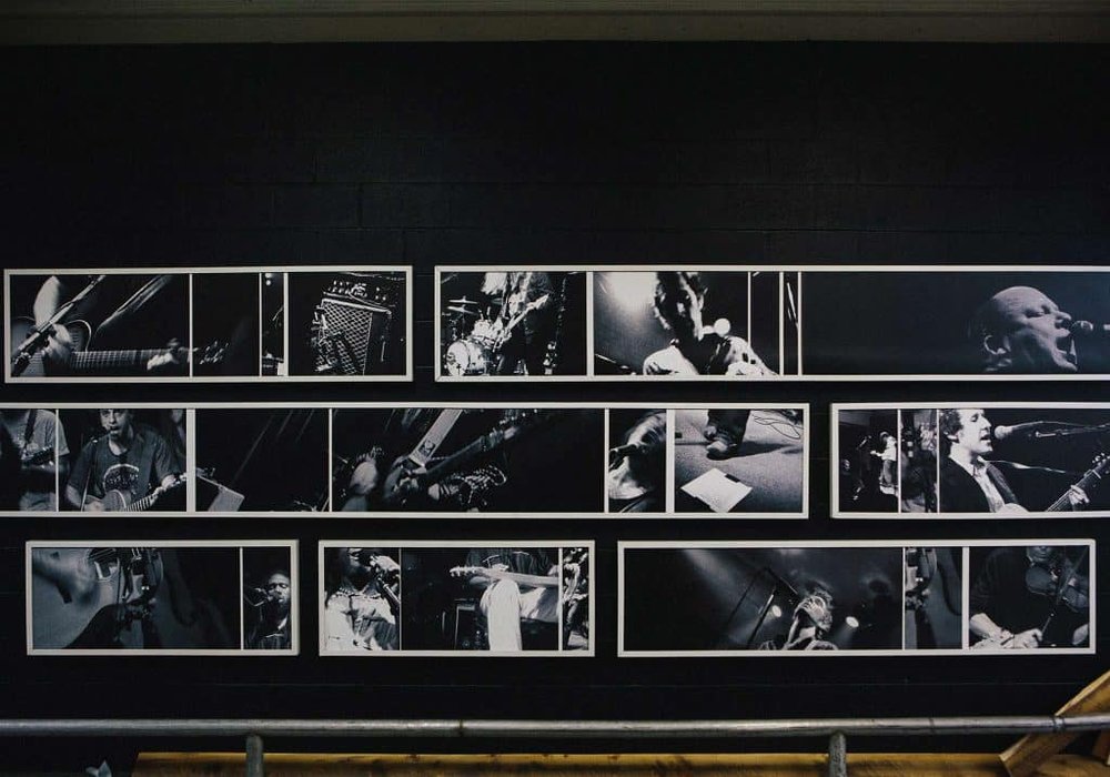  Photo wall in the Crozet production brewery featuring bands at the Music Hall. 