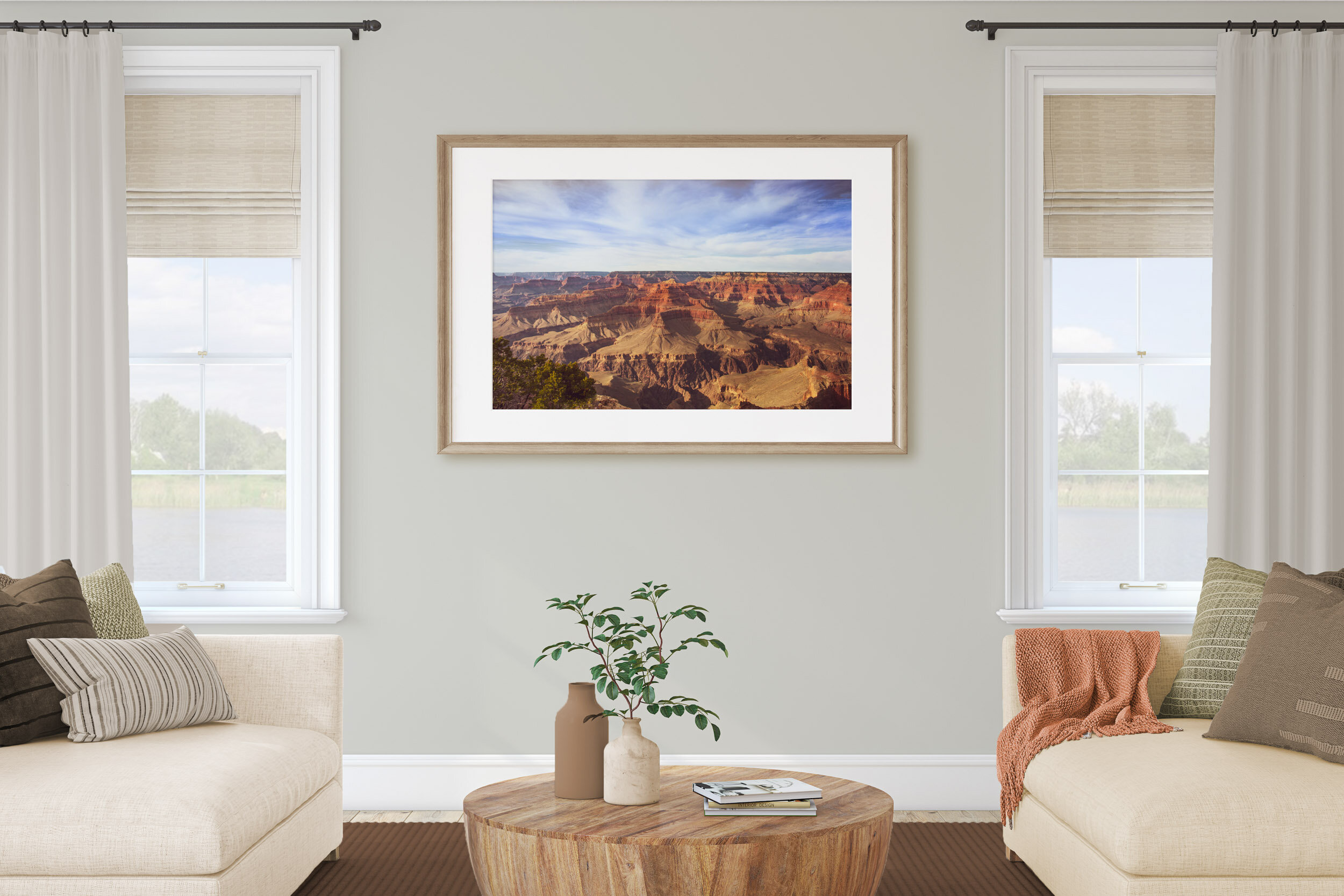 Very large framed photo in a room between two windows