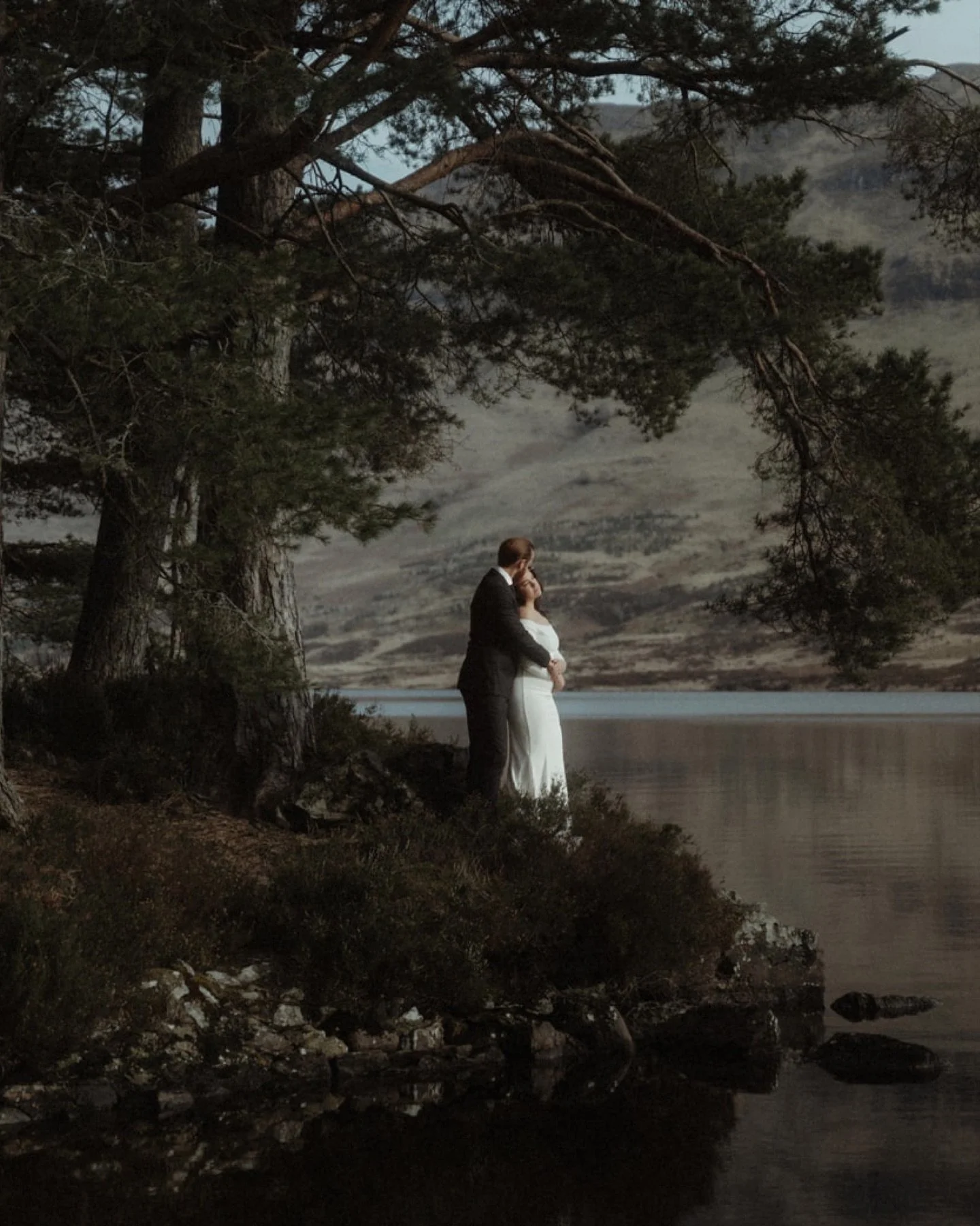 A secret location beneath the trees. ✨

On the banks of Loch Ard, at the edge of Queen Elizabeth Forest Park, Rhi &amp; James found their place of promise. Surrounded by towering pines and mirrored waters, their vows echoed softly through the stillne