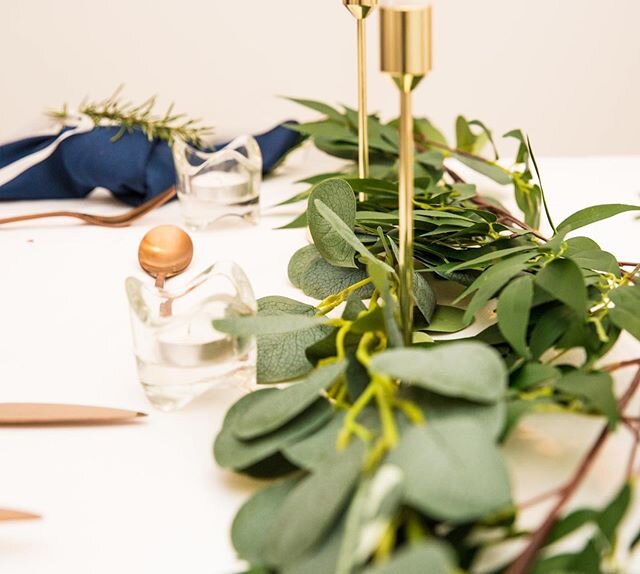 Table setting decor. 
Eucalyptus, rose gold cutlery and navy blue napkins. 
#weddings #events #eventtablesettings #eucalyptusrunner #navyandrosegoldwedding #goldacsents