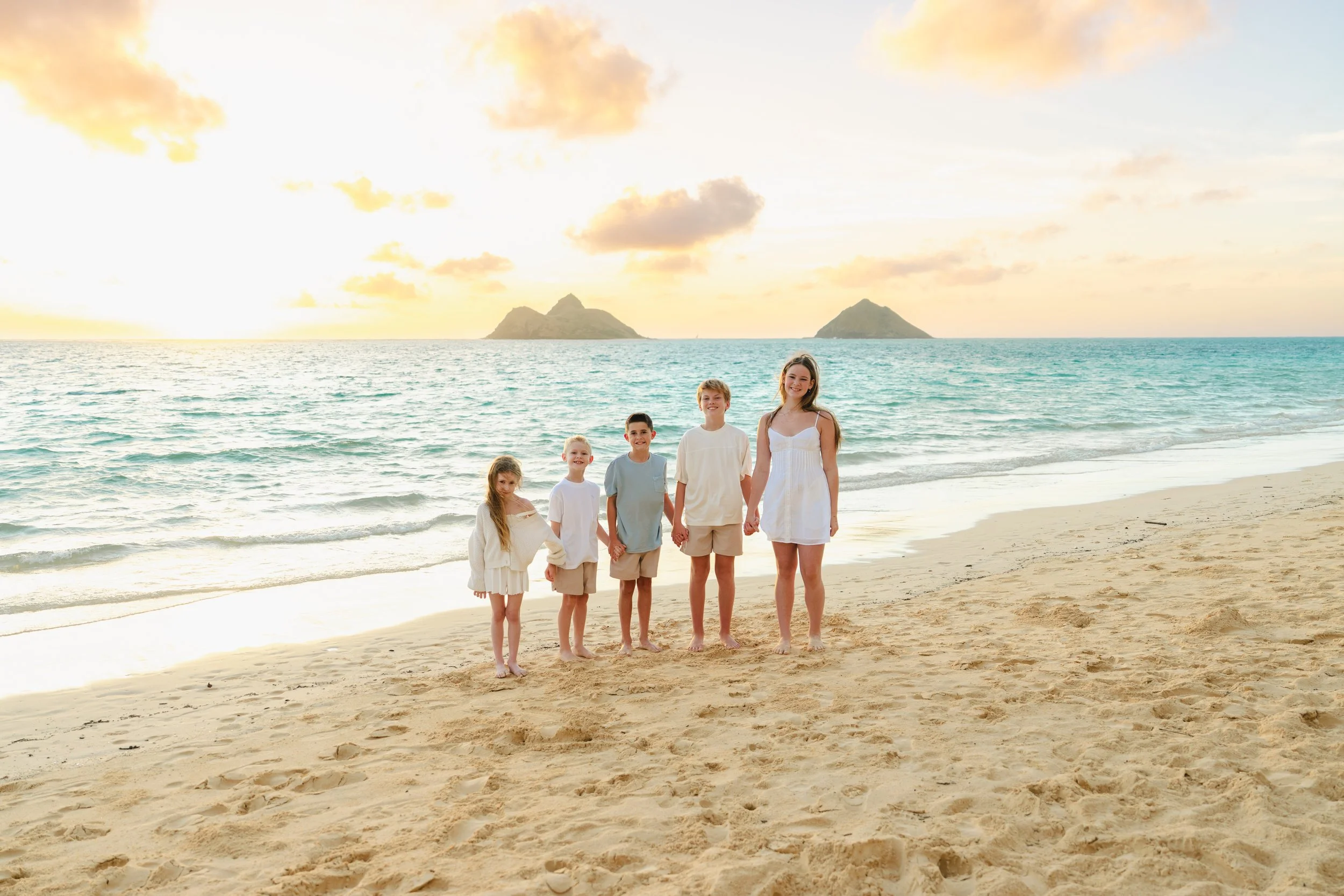 Five siblings photographed during a peaceful sunrise session at Lanikai Beach in Kailua