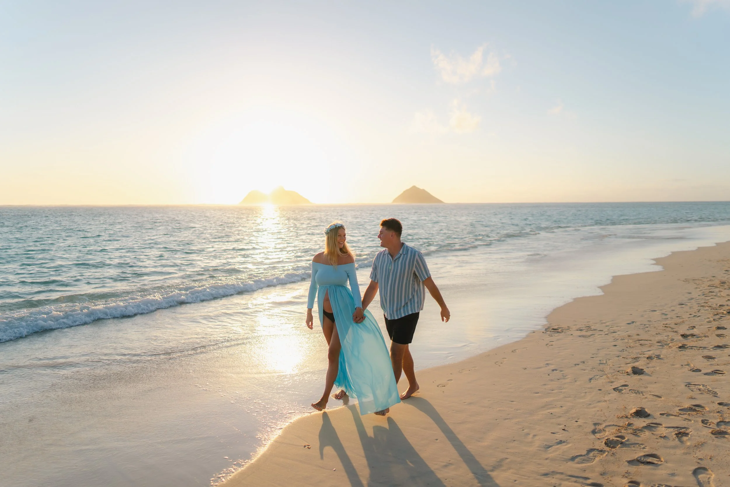 Maternity session by the shoreline at sunrise during an Oahu beach maternity photography session at Lanikai Beach.