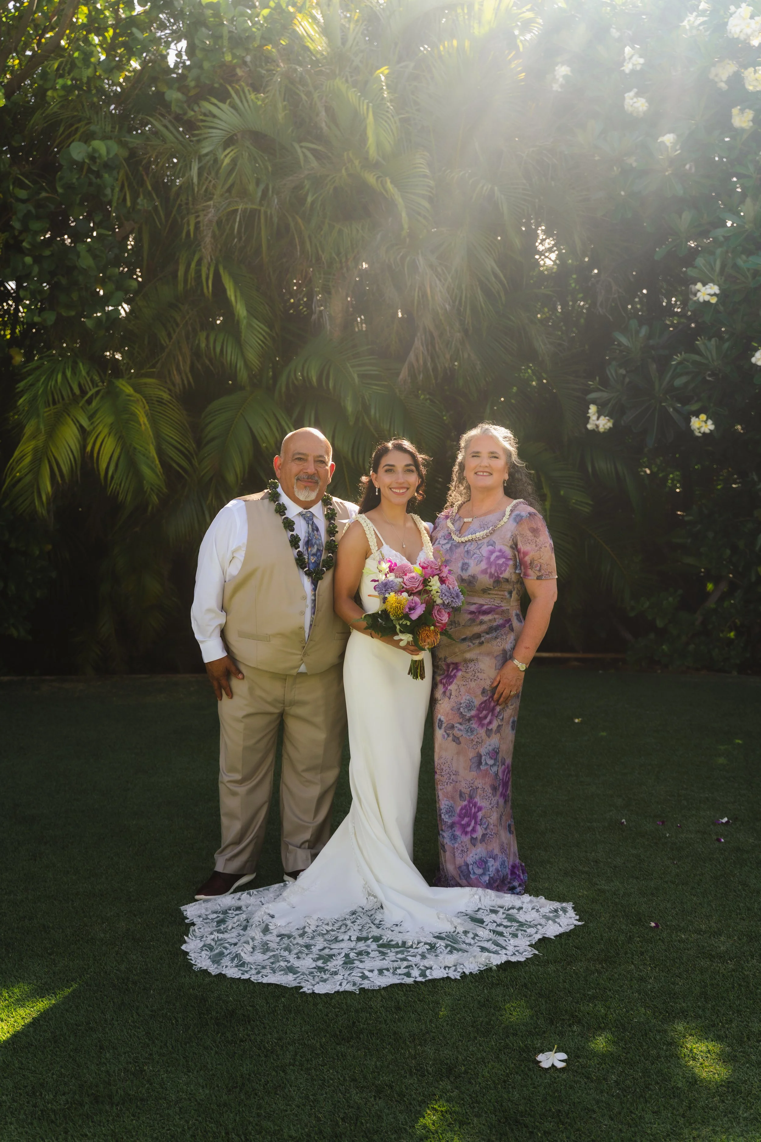 Bride photographed with her mother and father at her Kaimea Estates wedding on Oahu