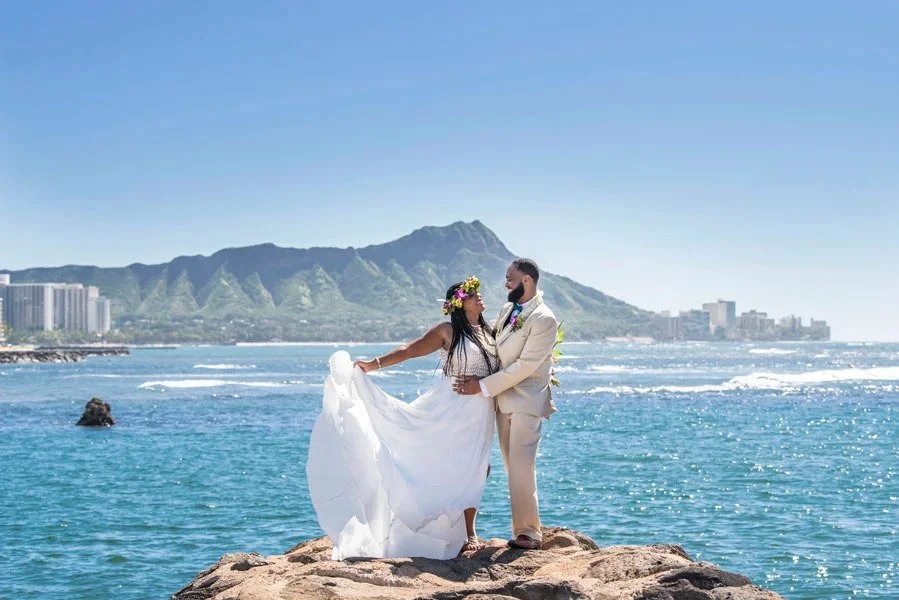 Couple celebrating their wedding by the ocean during an Oahu wedding photography session at Magic Island.