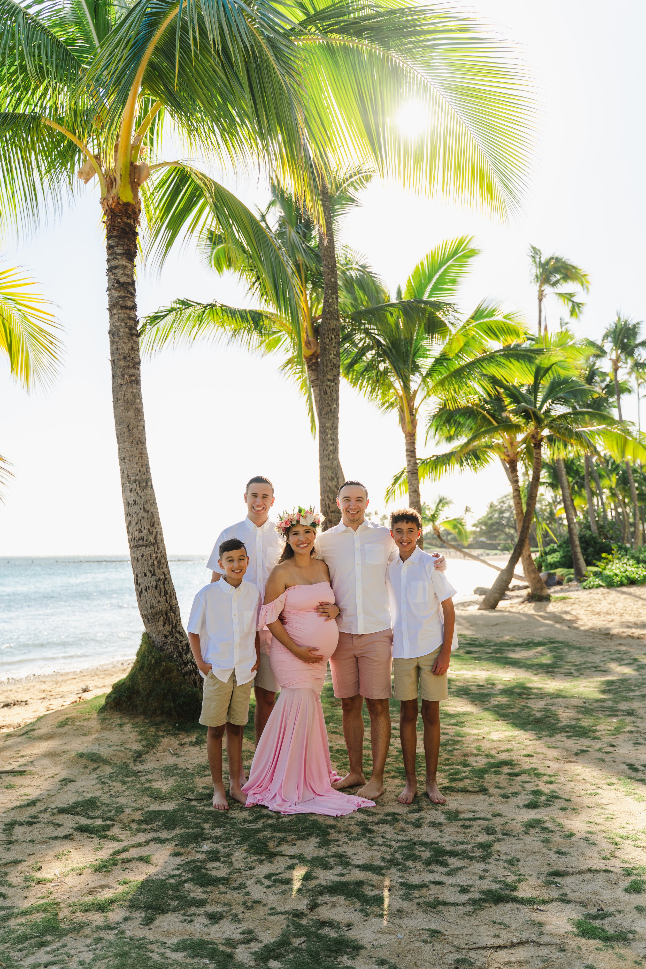 Maternity and family session on the beach during an Oahu family photographer shoot at Kahala Beach.