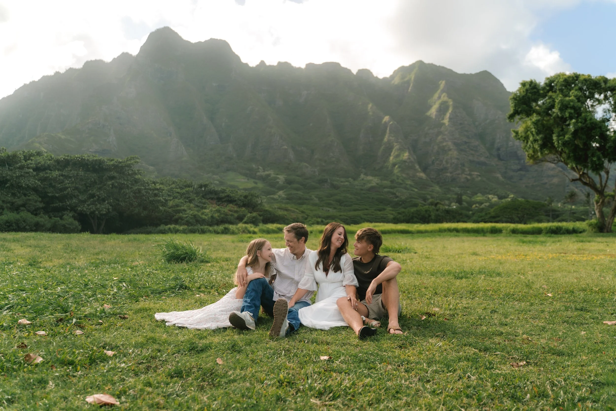 Family photography session at Kualoa Regional Park with the Koʻolau mountains in the background on Oahu