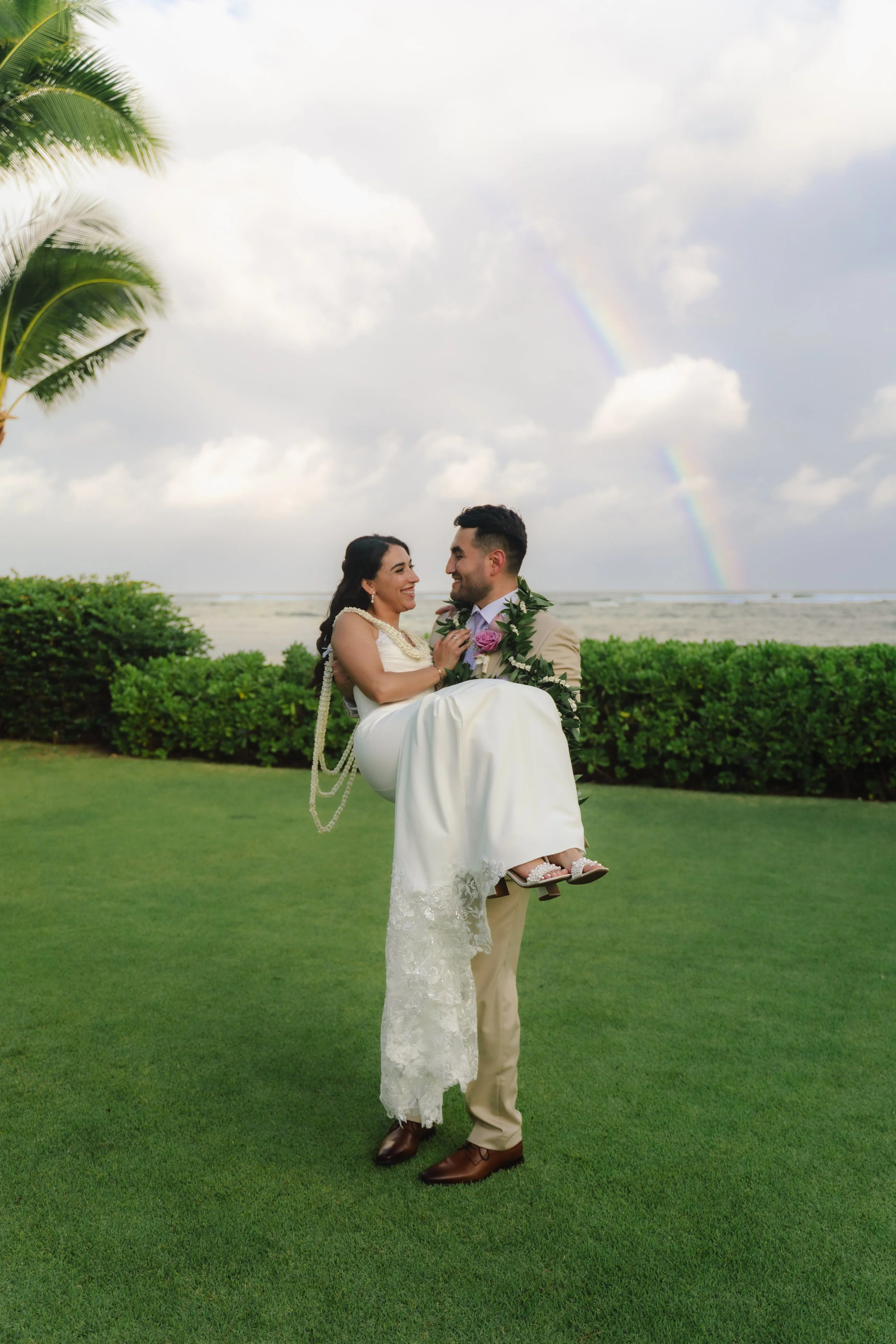 Newlywed couple photographed with a beautiful Hawaii rainbow during their Kaimea Estates wedding