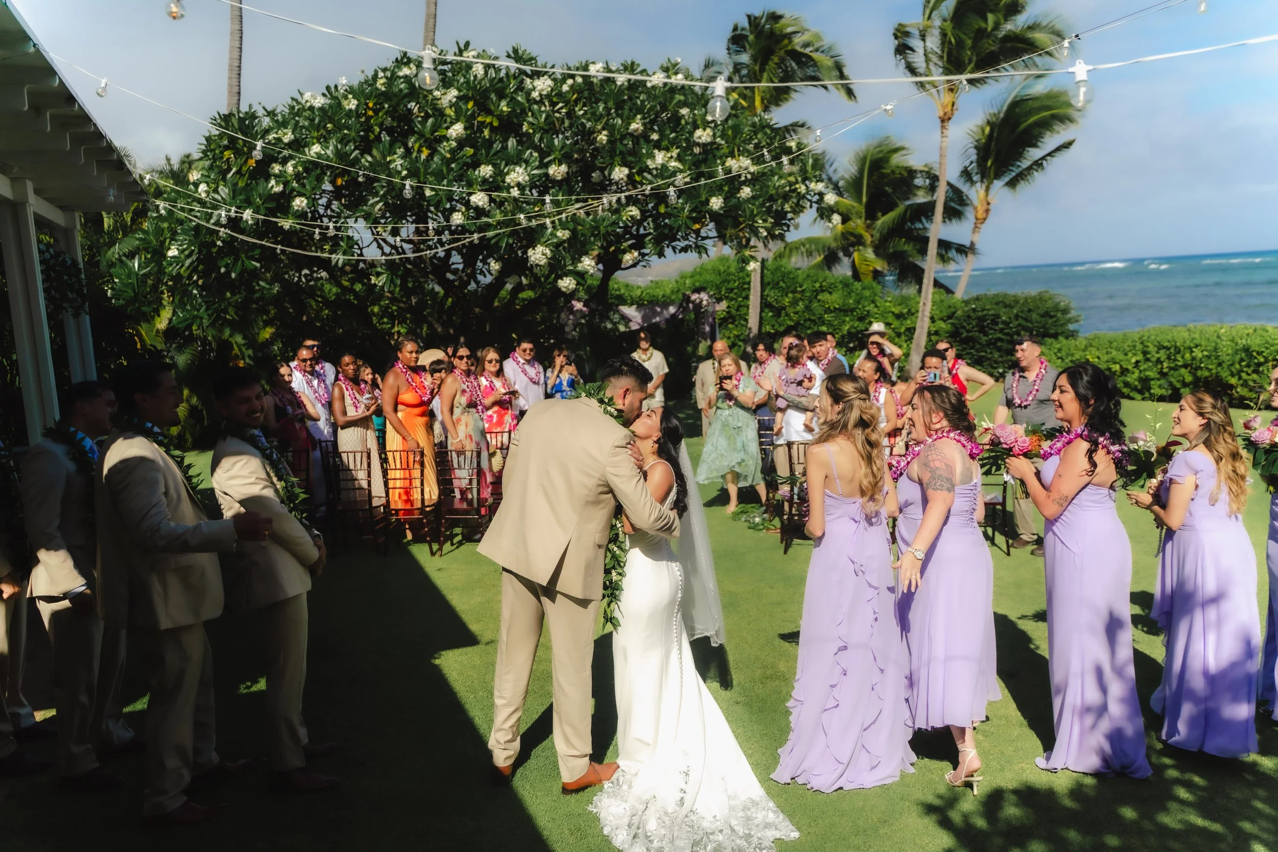 Newlyweds celebrating during their outdoor wedding ceremony at Kaimea Estates on Oahu