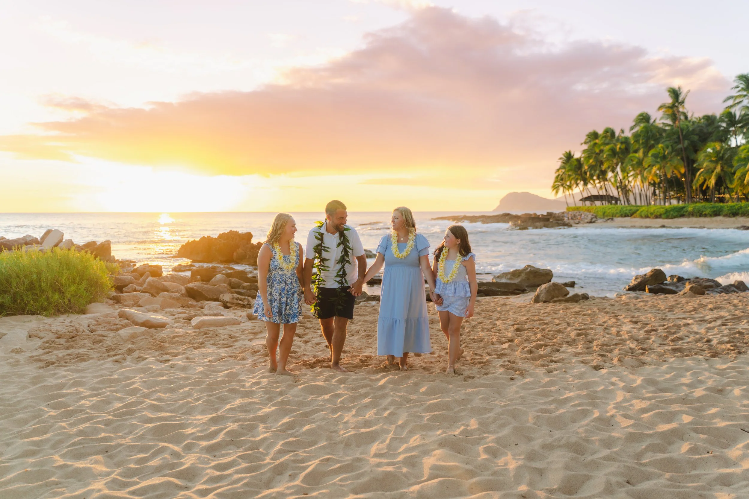Candid family photo during a sunset photography session at Secret Beach on Oahu
