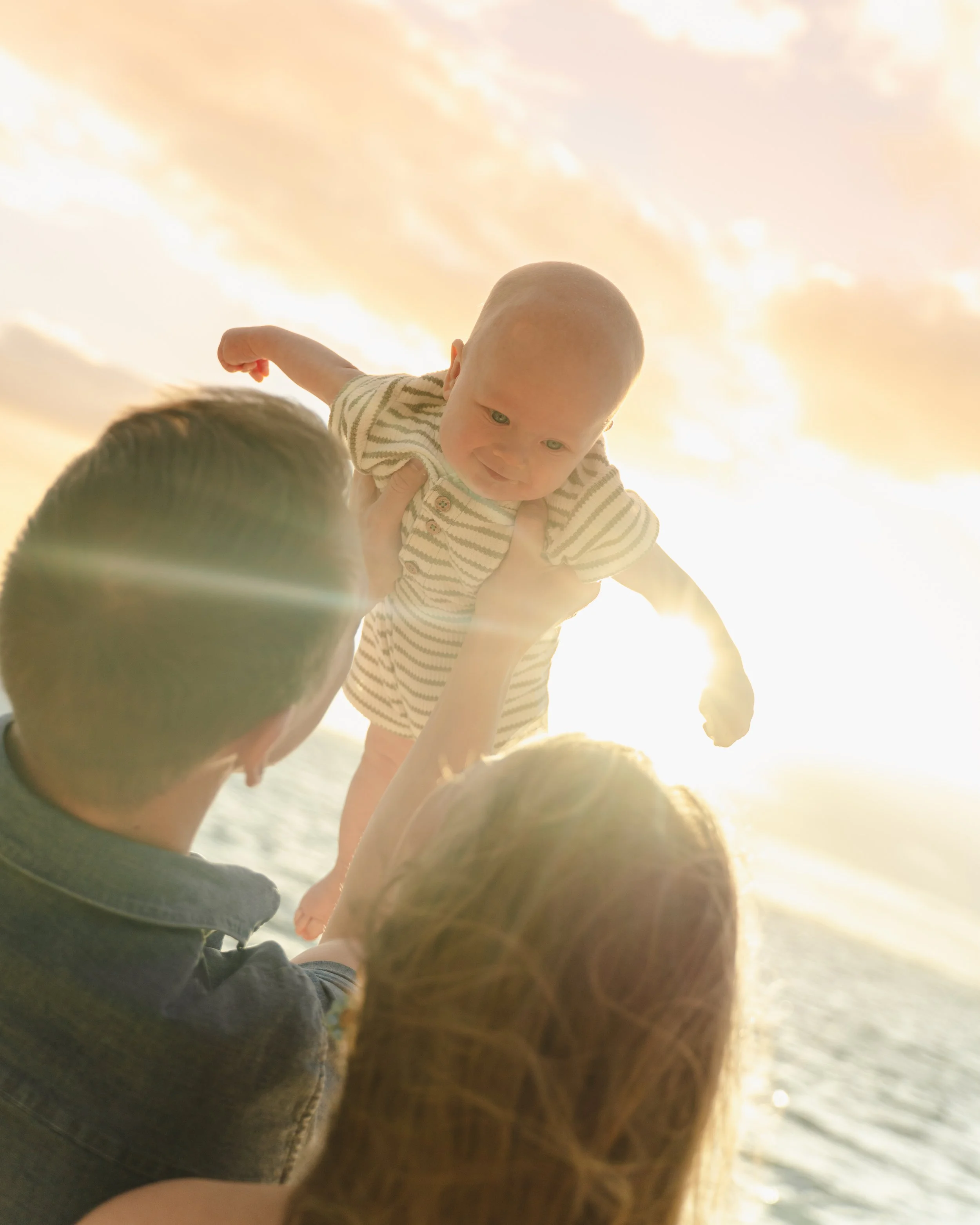 Sunrise newborn photography session at Kaaawa Beach on Oahu.