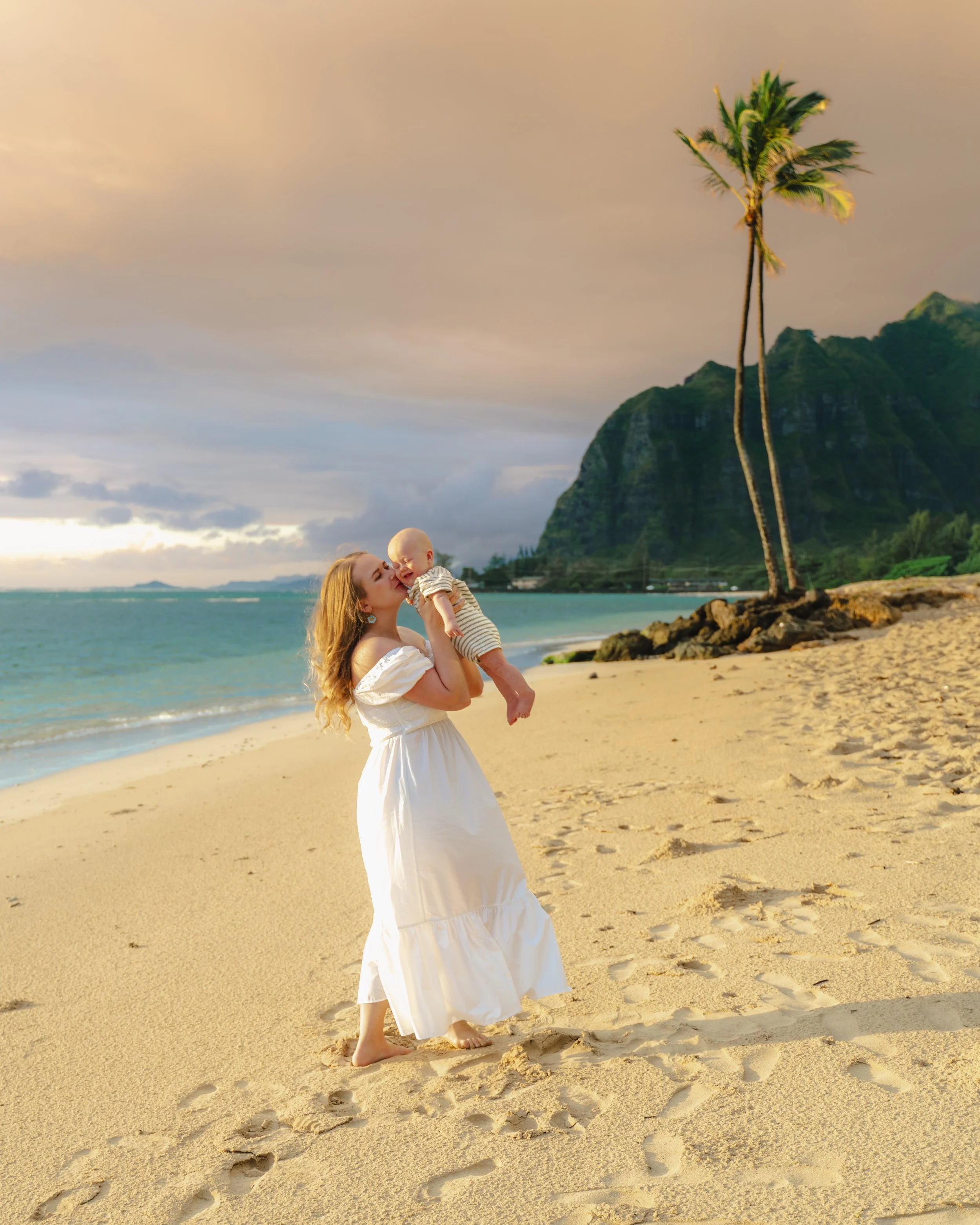 Family newborn photos at Kaaawa Beach during sunrise in Hawaii.