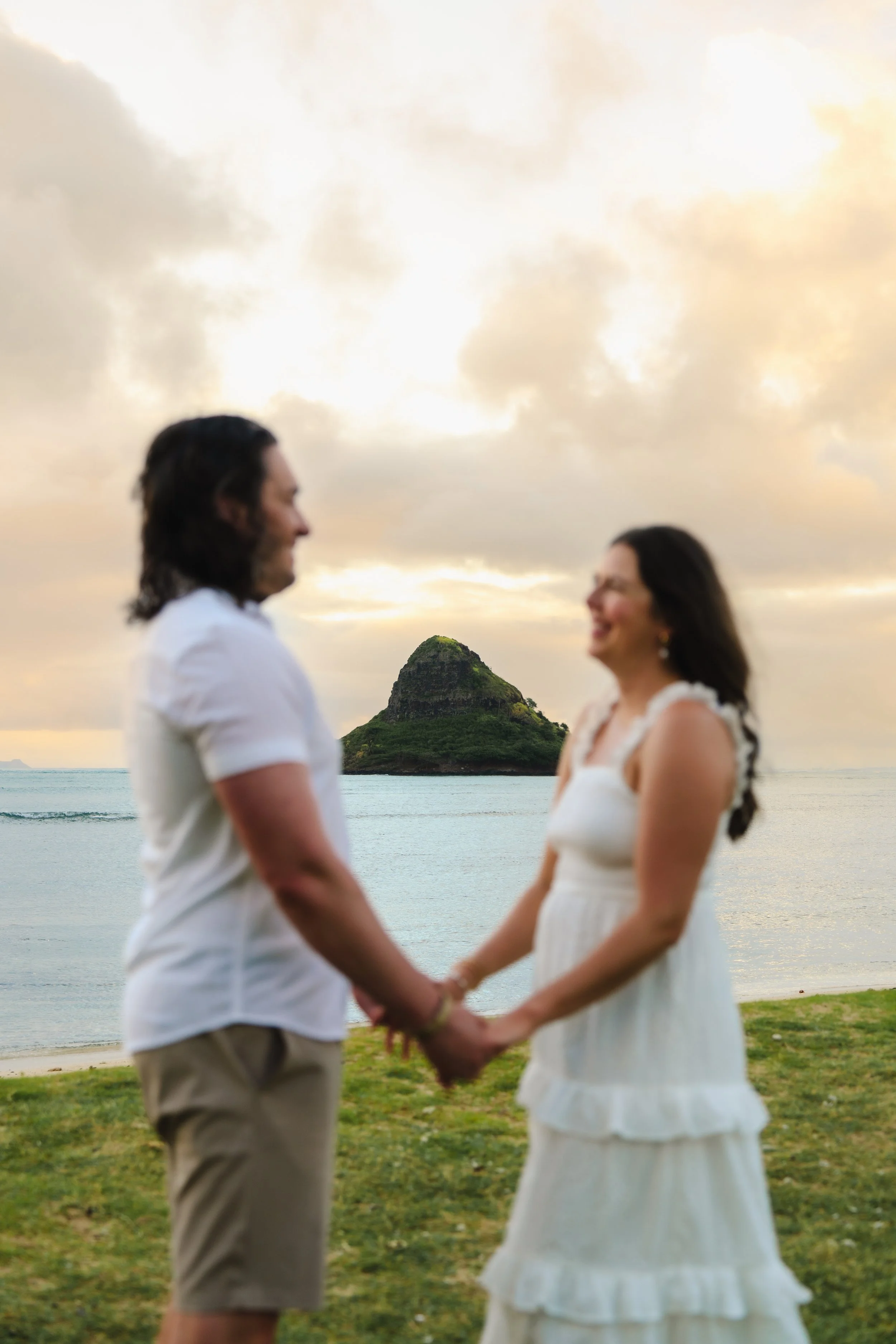 Couple celebrating their anniversary with sunrise portraits at Kualoa Regional Park on Oahu