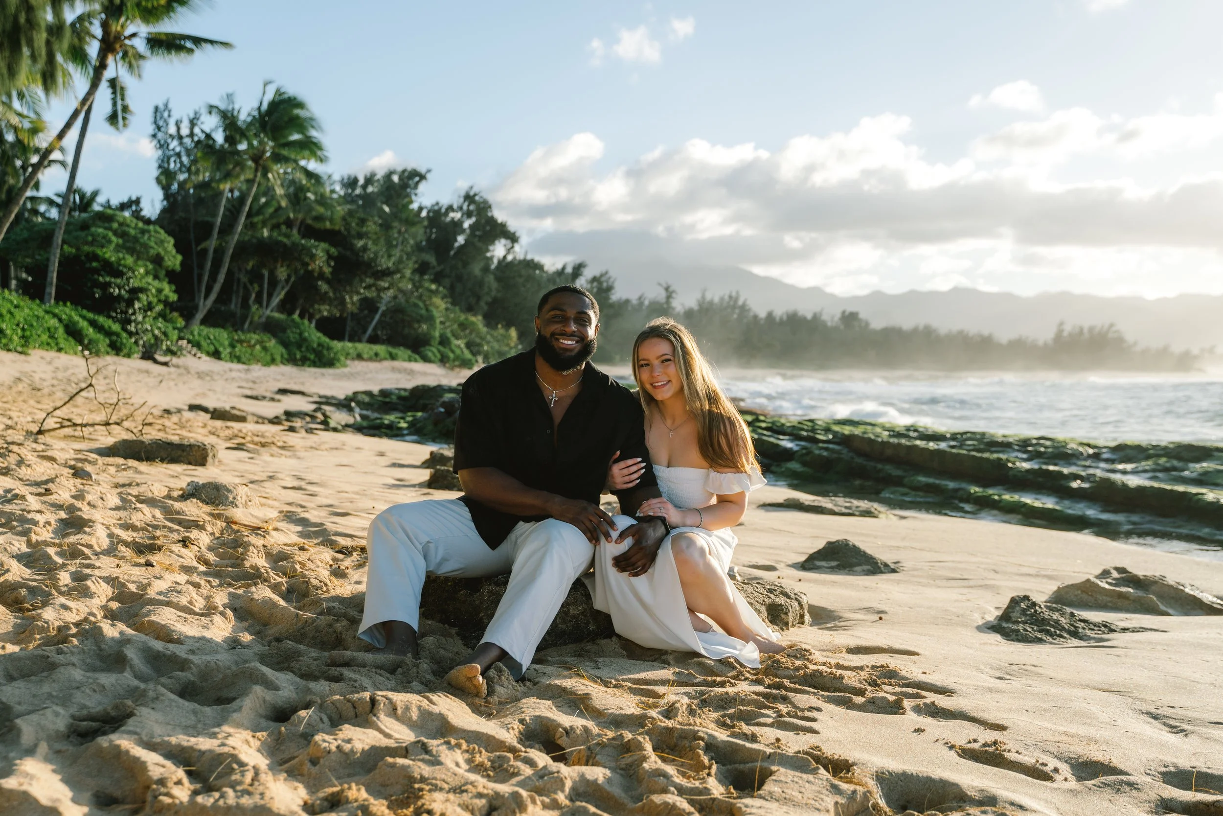 Couple sharing a quiet moment at sunset by the shoreline during an Oahu couples photo session at Papailoa Beach on the North Shore.
