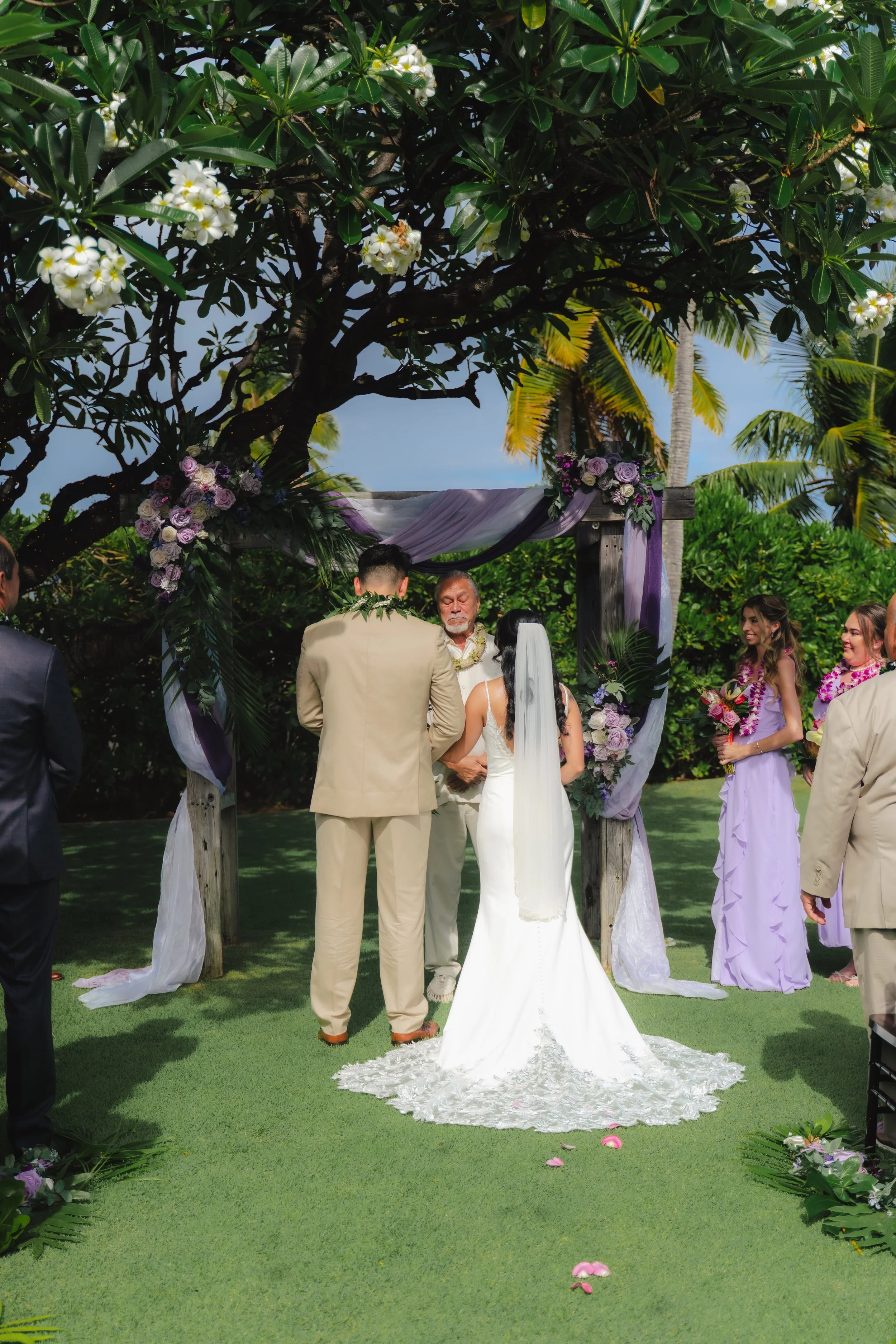 Couple exchanging vows during their wedding ceremony at Kaimea Estates on Oahu