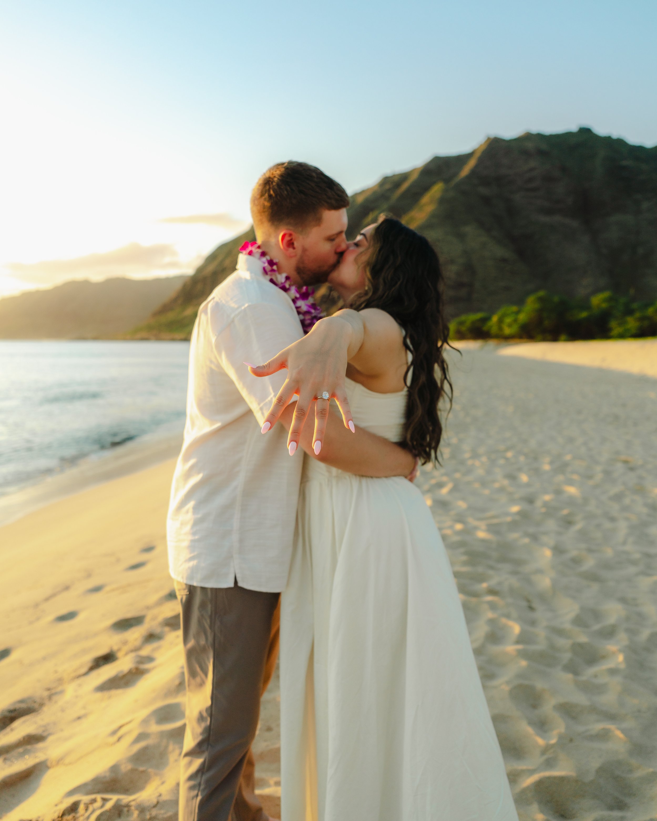 Surprise marriage proposal photographed at sunset on scenic Makua Beach on Oahu