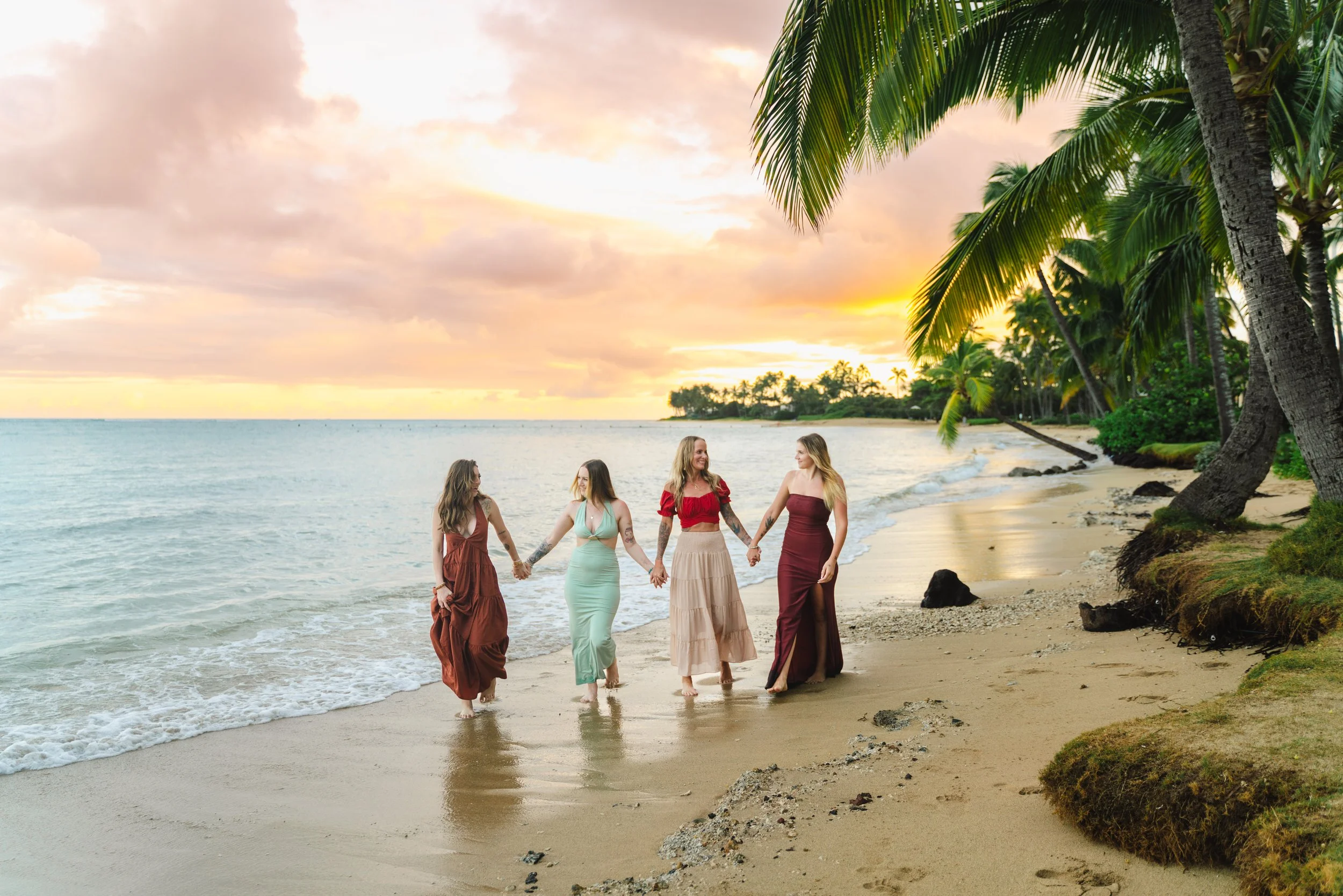 Family photographed together at sunset on beautiful Kahala Beach in Oahu