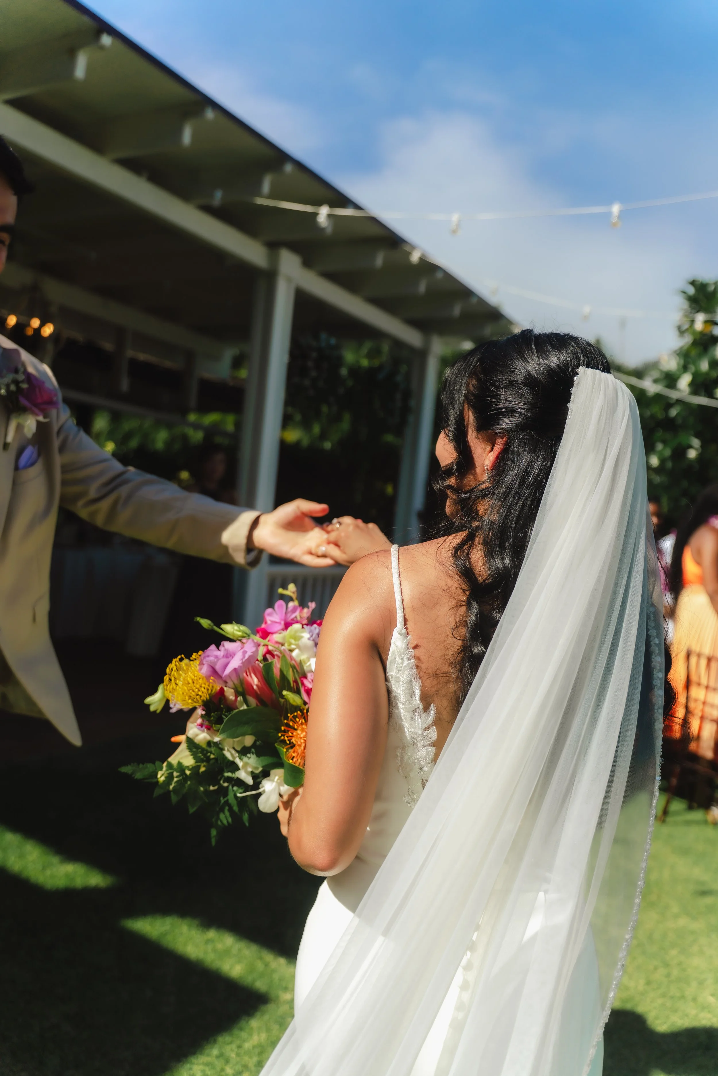 Bride and groom photographed during their outdoor ceremony at Kaimea Estates on Oahu