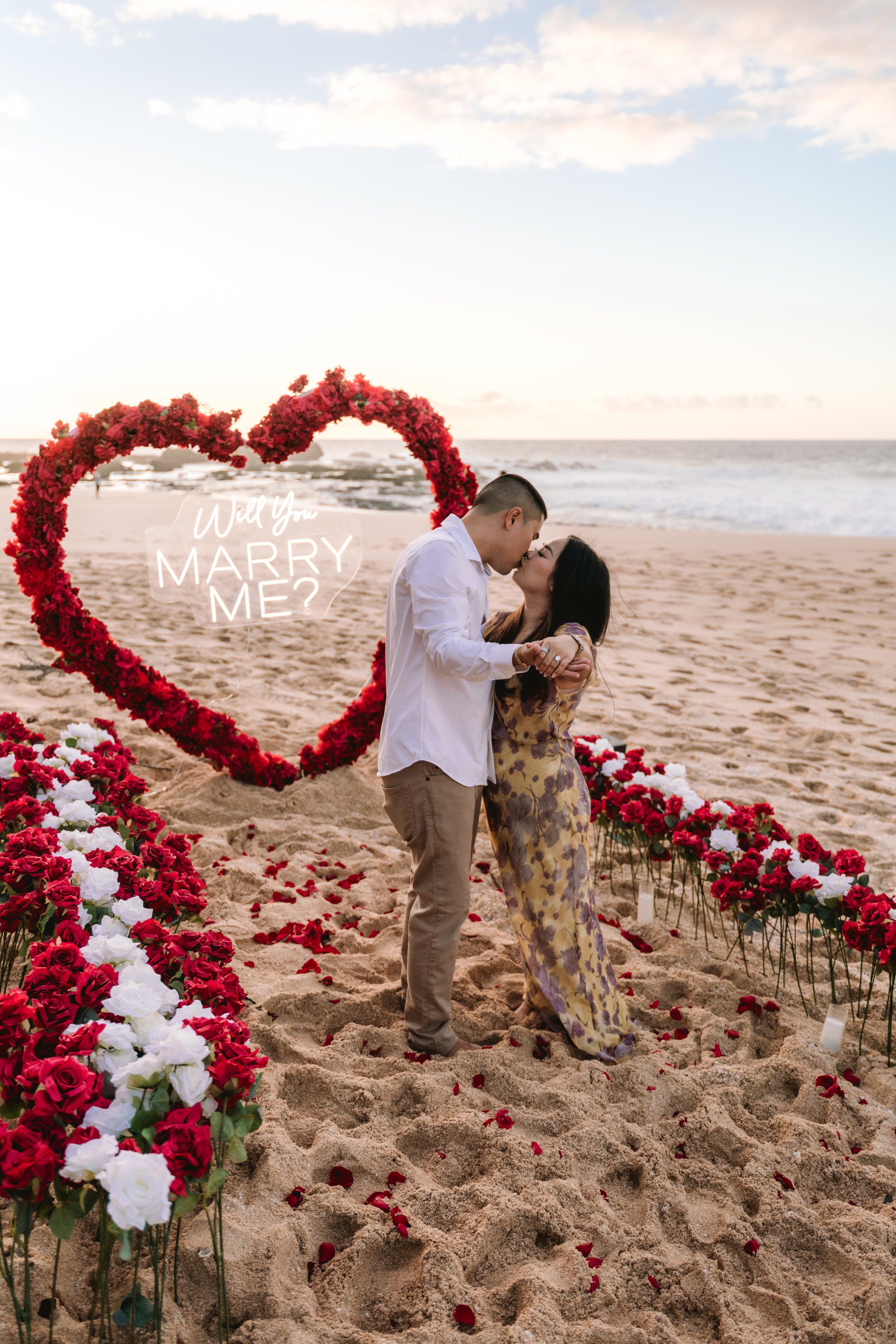 Surprise beach proposal captured on Oahu’s North Shore during a romantic photography session by the ocean.