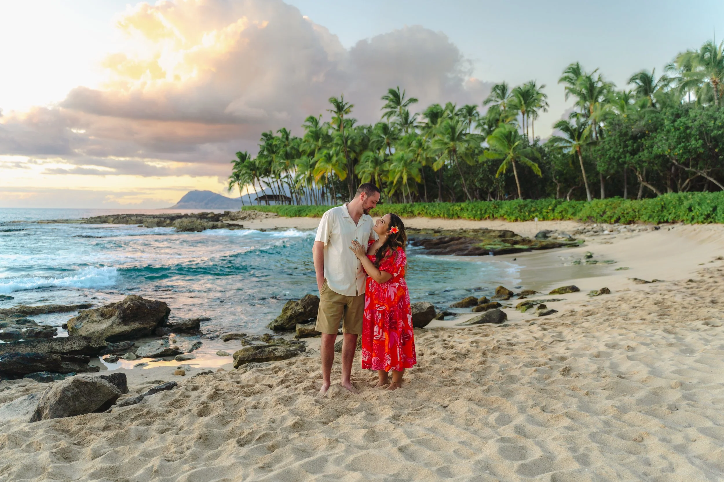 Couple walking together along the shoreline during an Oahu beach couples photography session at Secret Beach in Ko Olina near Disney Aulani.