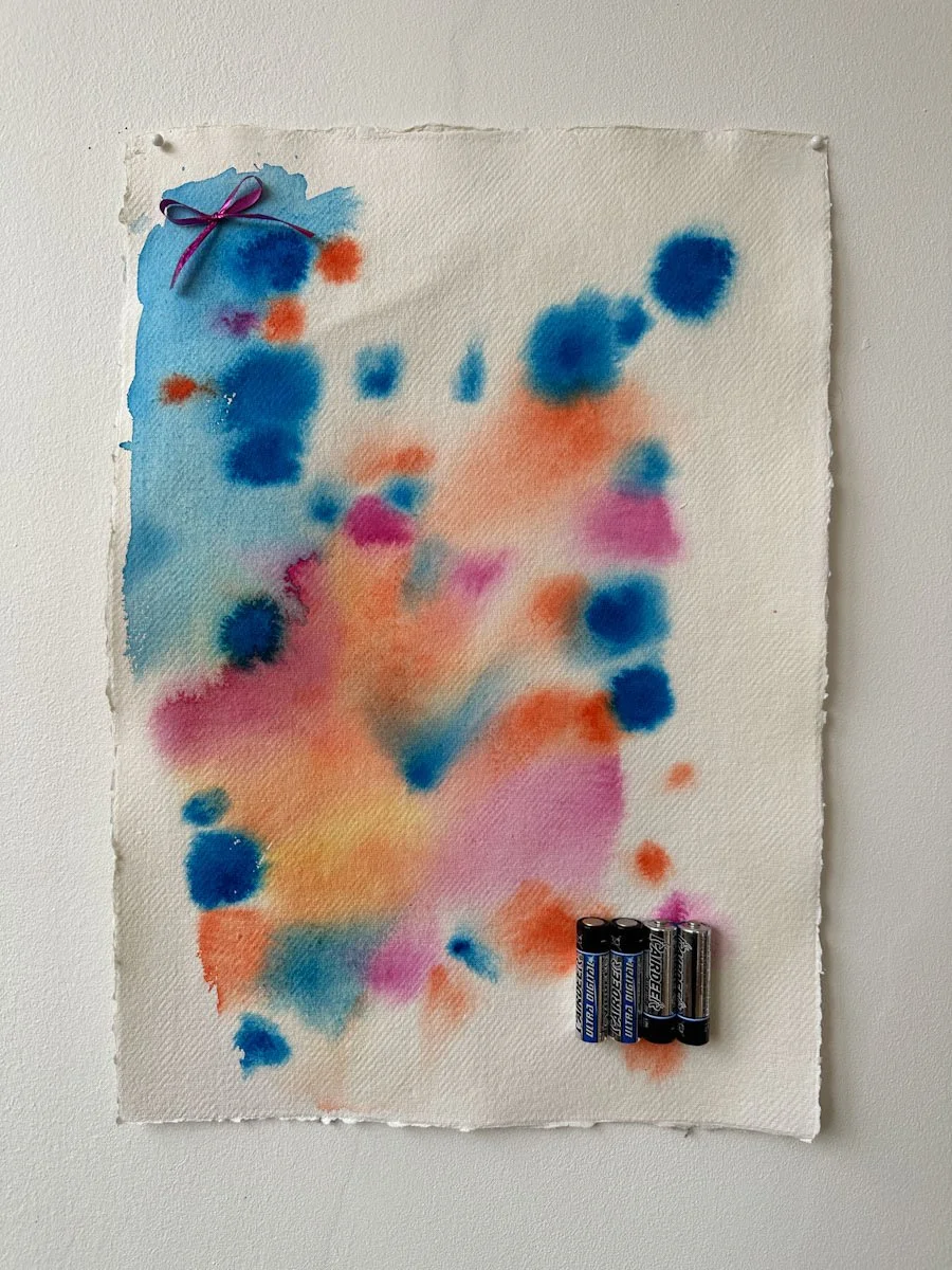 "Kiss Me Properly," watercolor, ribbon, and AA batteries on paper, 16.5 x 11.7 inches, 2024